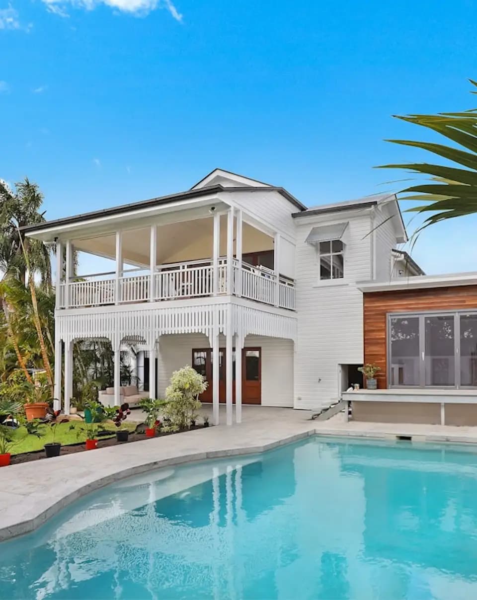 A white house with a pool in the tropics