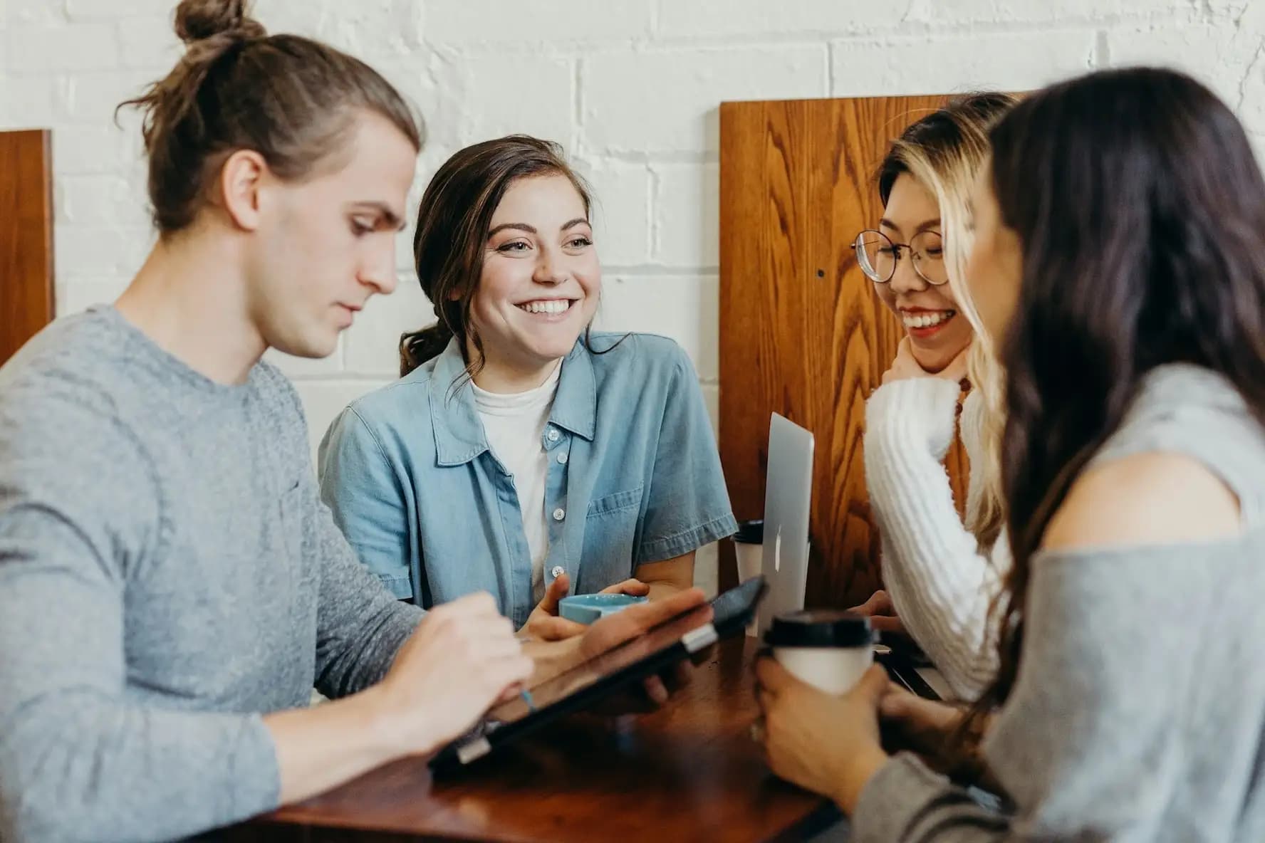 Group of young people working together and laughing in a casual setting